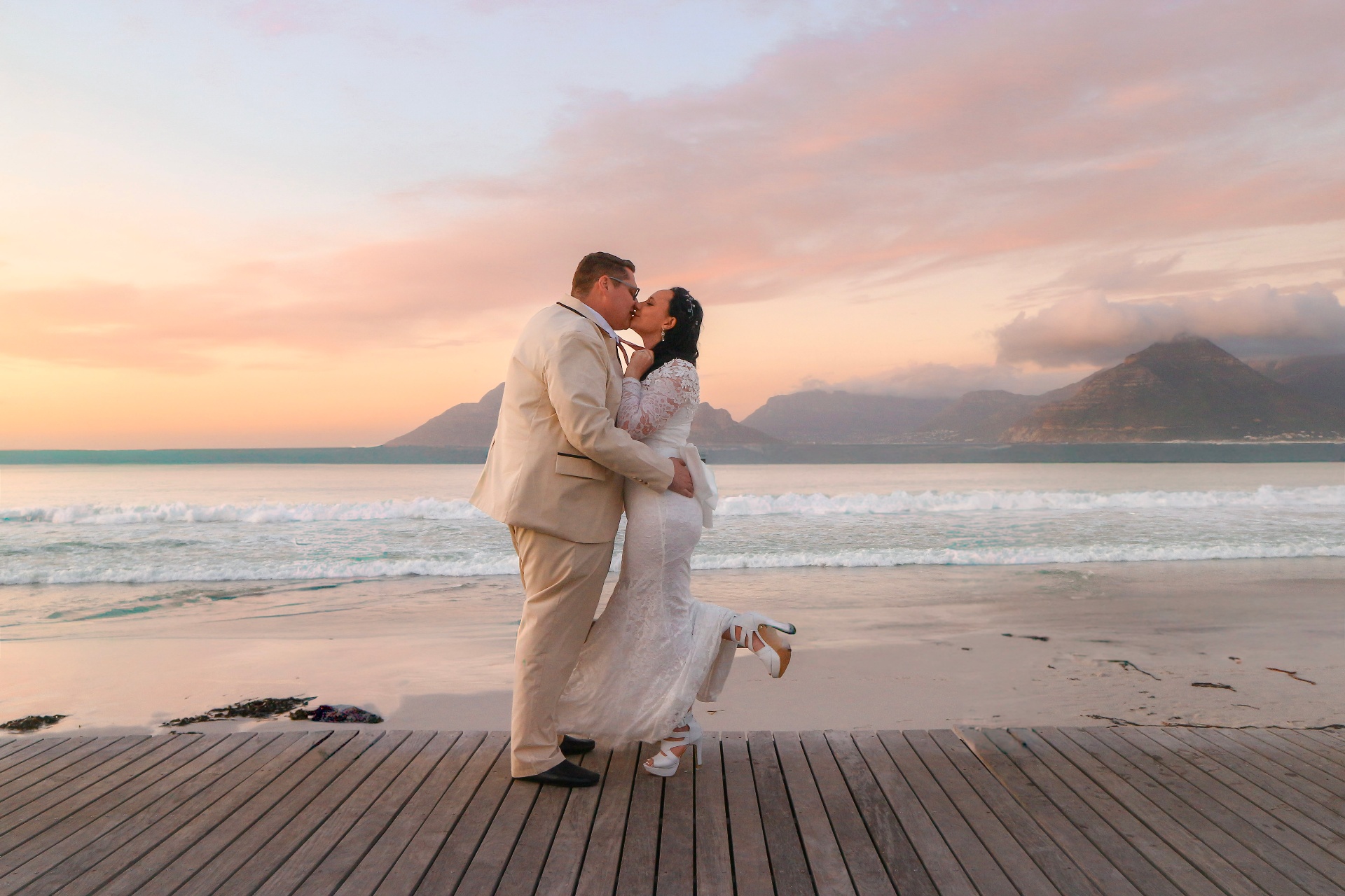 Couple kissing on the beach at sunset in Cape Town